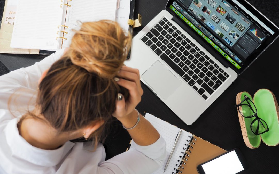 woman sitting in front of macbook